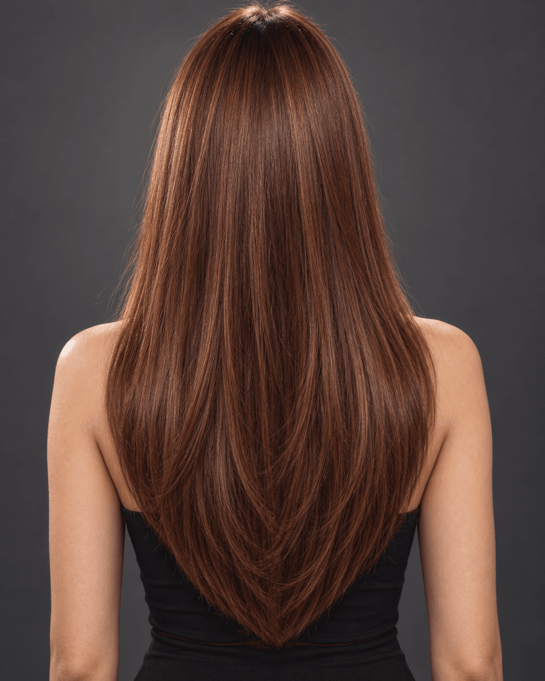 Back view of long auburn hair cut in a soft U-shaped layered silhouette.