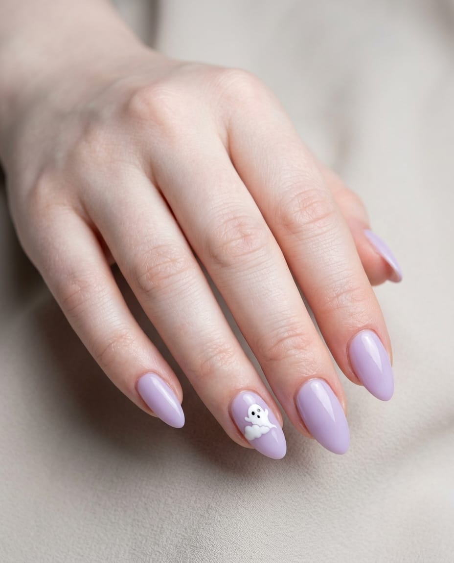 Hand with lavender acrylic nails and a ghost-behind-a-cloud accent nail design.