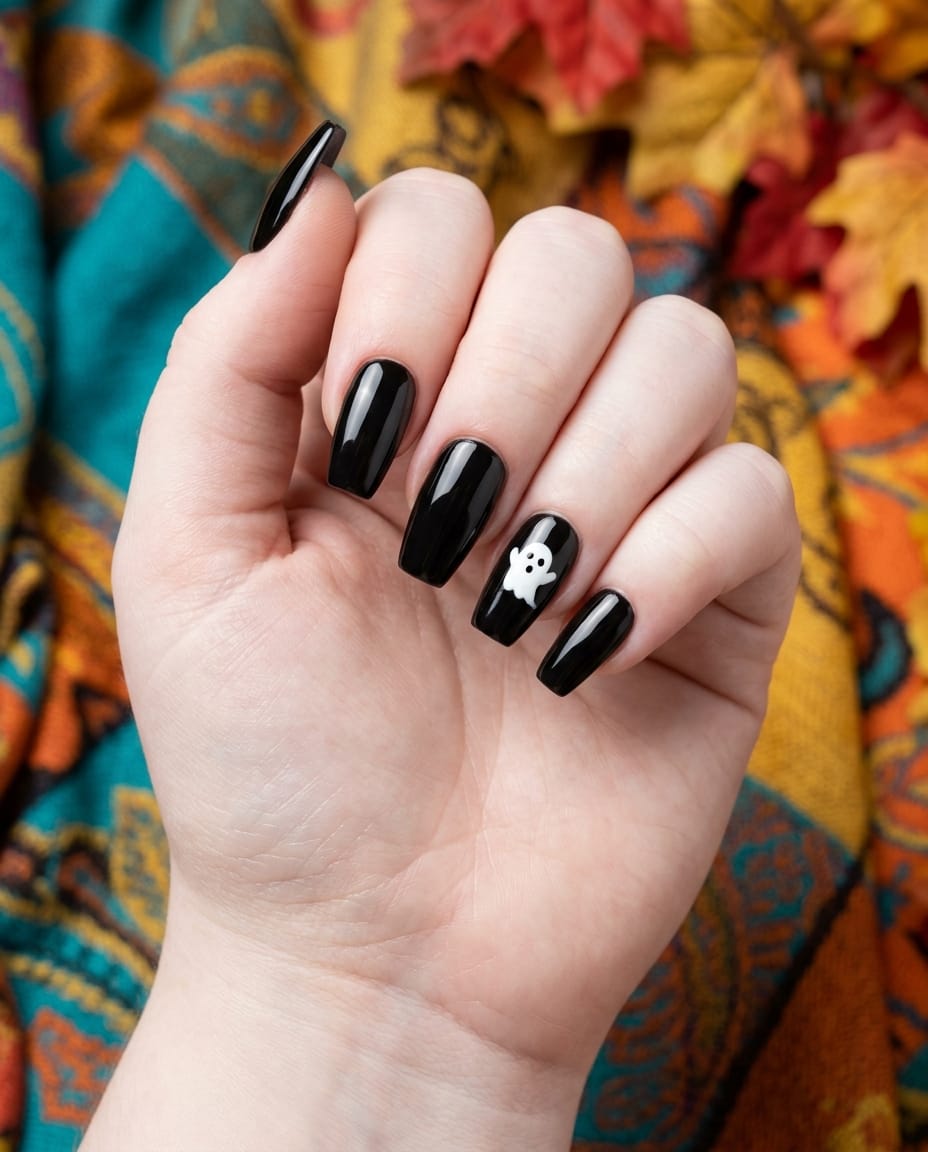 Hand with plain black nails and one simple white ghost dot accent nail