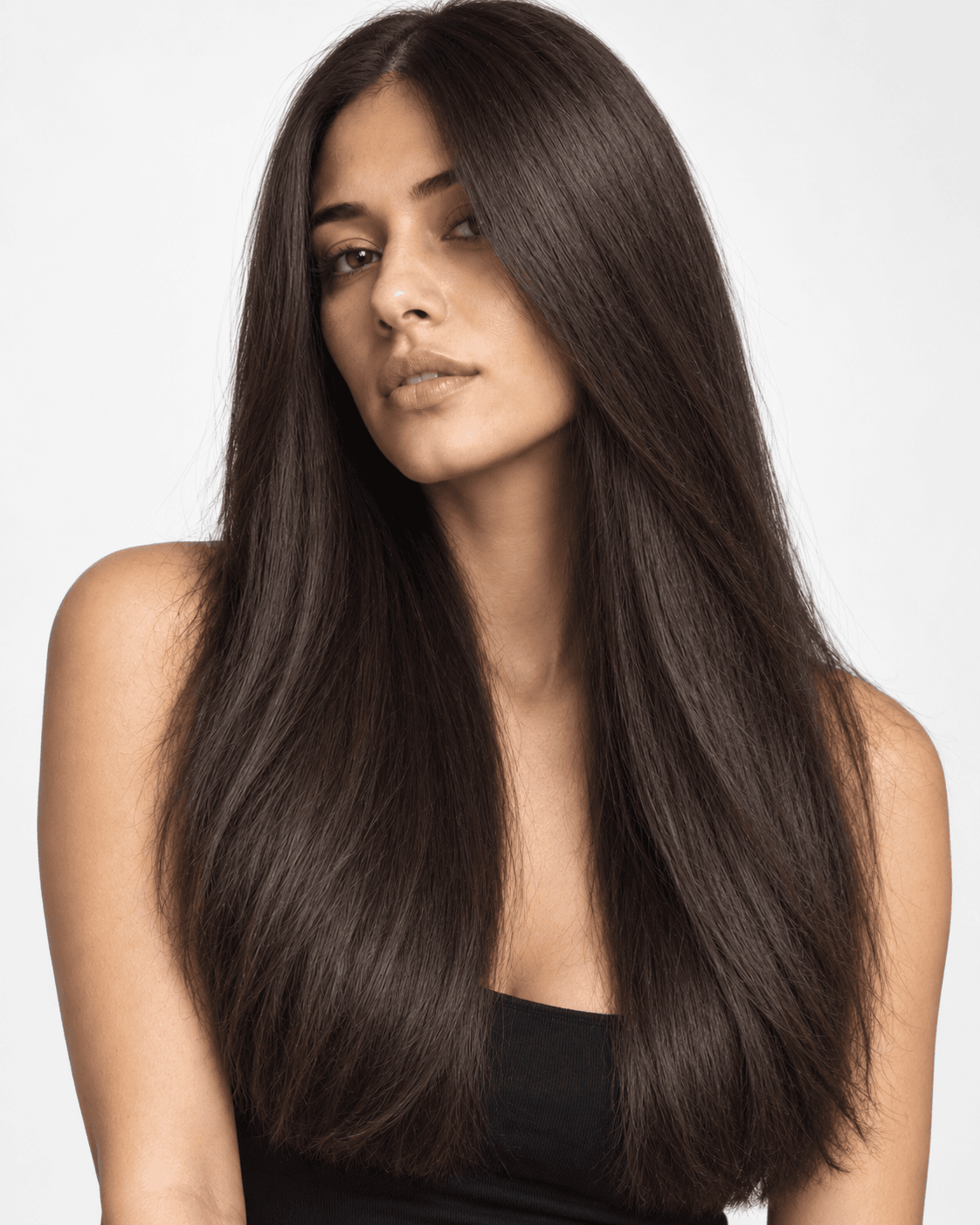 Long thick hair with a center part and minimal wide layering.